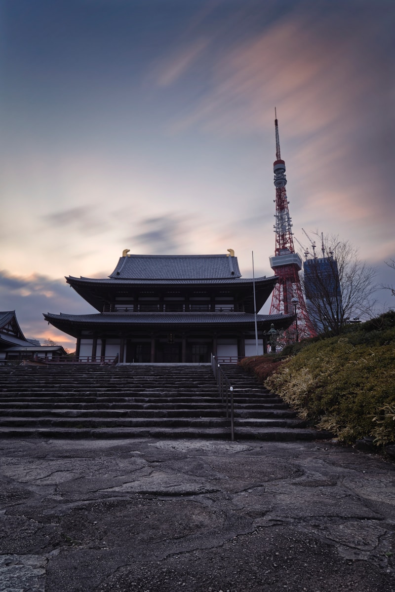 a very tall building with a tower in the background